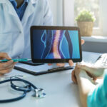 Doctor discussing spinal cord stimulator trial results and permanent implant expectations with a patient.